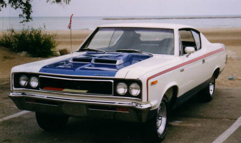 1970 AMC The Machine 2-door muscle car in RWB trim by lake